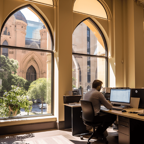 A Car Loan specialist working on his pc in Sydney Hyde Park