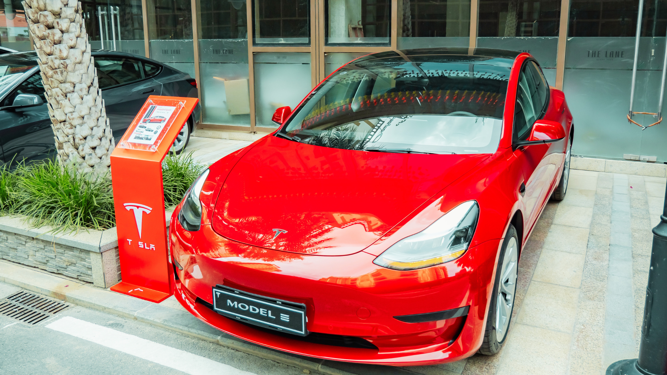 A red Tesla Model 3 Parked in Sydney, Australia